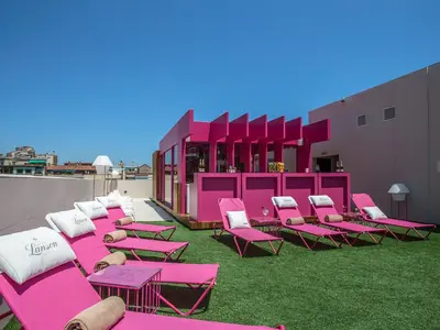 a group of pink chairs and tables on a roof at Axel TWO Barcelona 4 Sup - Adults Only in Barcelona