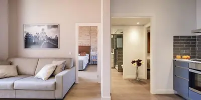 a living room with a couch and a bedroom at Pau Claris Double - Home next to Paseo de Gracia in Barcelona