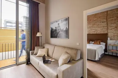 a living room with a couch and a bed at Pau Claris Double - Home next to Paseo de Gracia in Barcelona