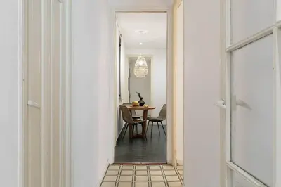 a hallway with white walls and a white tile floor at Veduto - 2 bedrooms in Eixample Esquerra in Barcelona