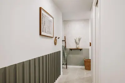 a living room with pots and pans hanging on a wall at Mojacar - 2 bedrooms in Eixample Esquerra in Barcelona