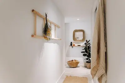 a hallway with white walls and a mirror at Botijo - 2 bedrooms in Eixample Esquerra in Barcelona