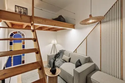 a living room with a couch and a television at Panot - 2 bedrooms and terrace in Gràcia in Barcelona