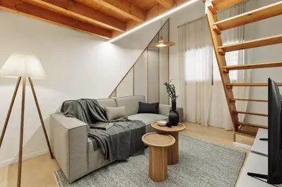 a patio with a couch and an umbrella on a balcony at Panot - 2 bedrooms and terrace in Gràcia in Barcelona