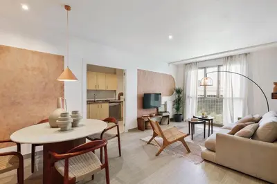 a living room with a couch and a table at Sole - 2 bedrooms in Poblenou in Barcelona
