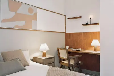 a bedroom with a bed and a desk with a chair at Sole - 2 bedrooms in Poblenou in Barcelona
