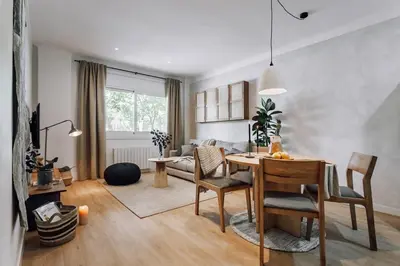 a living room with a table and a couch at Arros - 2 bedroom in El Born in Barcelona