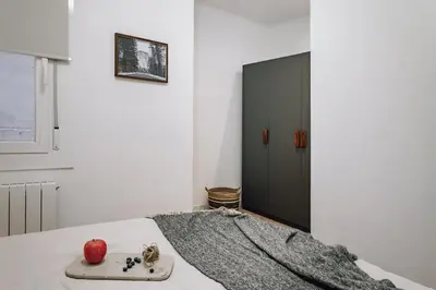 a bedroom with a large bed with an apple on it at Arros - 2 bedroom in El Born in Barcelona