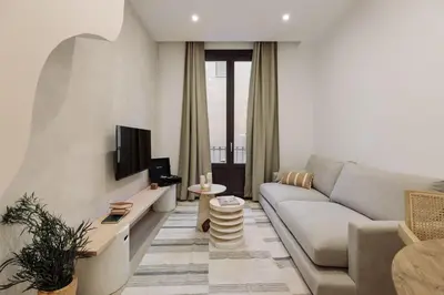 a desk with a mirror and a vase on it at Praiano - 2 bedrooms, balcony and terrace in Ciutat Vella in Barcelona
