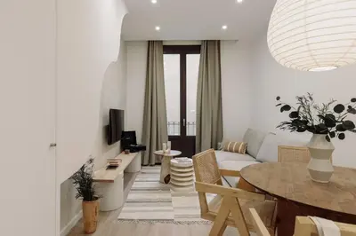 a bedroom with a bed and a desk and a table with a chair at Praiano - 2 bedrooms, balcony and terrace in Ciutat Vella in Barcelona