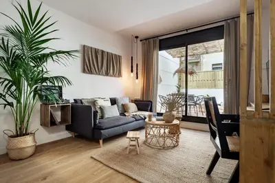 a bedroom with a large bed and a large window at Bintan - 1 bedroom and terrace in Gràcia in Barcelona