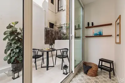 a bedroom with a bed and a desk and shelves at Halite - 2 bedrooms, terrace, and balcony in Gràcia in Barcelona