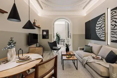a living room with a bed and a desk at Halite - 2 bedrooms, terrace, and balcony in Gràcia in Barcelona