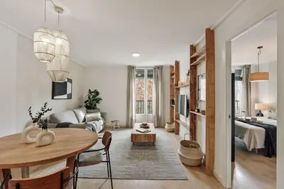 a living room with a desk and a table at Canet - 1 bedroom in Ciutat Vella in Barcelona