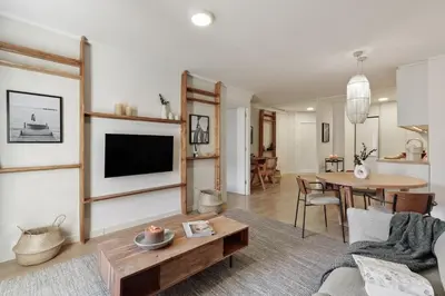 a kitchen and living room with a table and a couch at Canet - 1 bedroom in Ciutat Vella in Barcelona