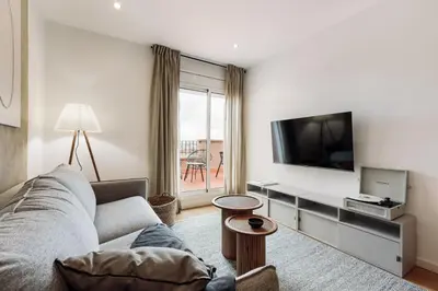a living room with a couch and a table at Quinta - 1 bedroom in Sants in Barcelona