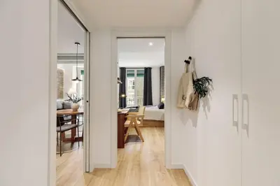 a bedroom with a bed and a desk with a desk at Ebre - 1 bedroom and balcony in Eixampre Esquerre in Barcelona