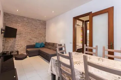 a living room with a couch and a table at Modern pad in a great old barrio in Barcelona
