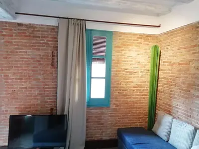 a living room with a blue couch and a window at Barceloneta Mar Street - BM11 in Barcelona