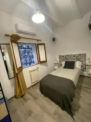 a bedroom with a bed and a window at Habitación El Patufet en Casa Camí de les Aigües Monistrol de Montserrat in Monistrol