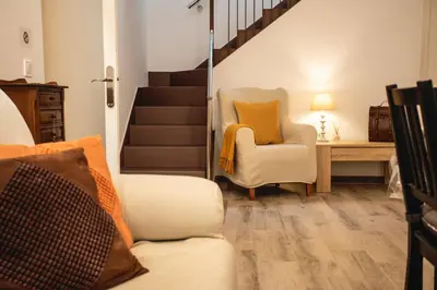 a staircase leading to a dining room with a table at Habitación El Patufet en Casa Camí de les Aigües Monistrol de Montserrat in Monistrol