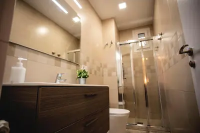 a bathroom with a shower with a toilet and a sink at Habitación Roca Foradada en Casa Camí de les Aigües Monistrol de Montserrat in Monistrol
