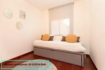 a bedroom with a bed with two pillows on it at Enjoy Apartments Calle Paris Super Stylish II in Barcelona