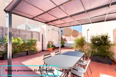 a patio with a table and chairs on a roof at Enjoy Apartments Calle Paris Super Stylish II in Barcelona