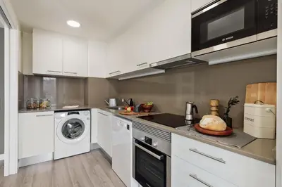 a kitchen and dining room with a table and chairs at Oreneta - 1 bedroom and pool in Les Corts in Barcelona