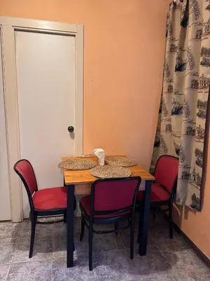 a table and chairs with a door and a table and chairs sidx sidx at Habitación camp nou in Barcelona