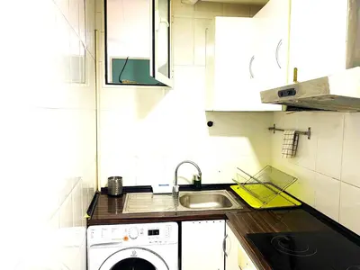a small kitchen with a washing machine and a sink at L5 Metro Stadium Home in Hospitalet de Llobregat