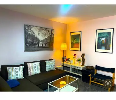 a living room with a couch and a table at L5 Metro Stadium Home in Hospitalet de Llobregat