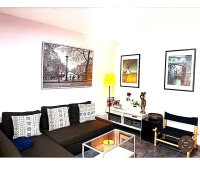 a living room with a couch and a table at L5 Metro Stadium Home in Hospitalet de Llobregat