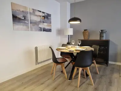 a dining room with a table and chairs at QEhome - confort, parking y cargador EV en el centro de Manresa in Manresa