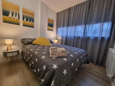 a bedroom with a bed with stars on it at QEhome - confort, parking y cargador EV en el centro de Manresa in Manresa