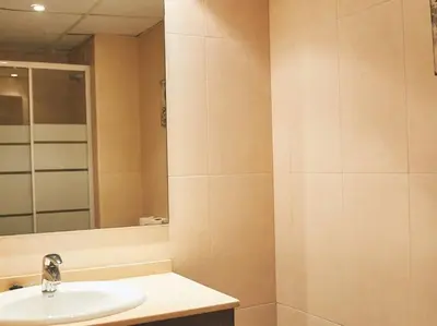 a bathroom with a sink and a mirror at Alcam Cervantes Playa Badalona in Badalona