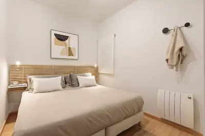 a bedroom with a large white bed in a room at Enjoy Apartments Ecuador in Barcelona