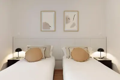 two beds sitting next to each other in a bedroom at Enjoy Apartments Ecuador in Barcelona