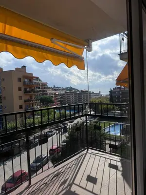 a balcony with a view of a pool and buildings at Caldetas relax apartment in Sant Vicenç de Montalt