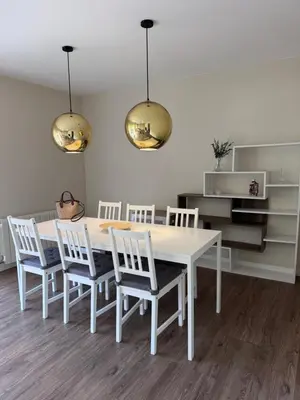 a white dining room with a white table and chairs at Caldetas relax apartment in Sant Vicenç de Montalt
