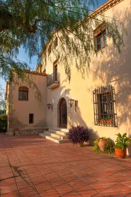a house with a brick walkway in front of it at Can Julià de Masia Olivera in Subirats