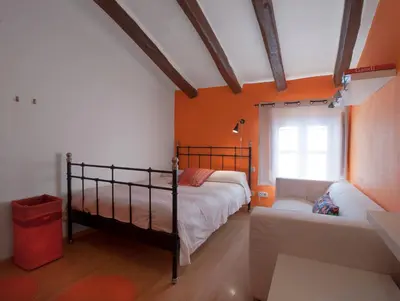a bedroom with two bunk beds and a window at Can Julià de Masia Olivera in Subirats