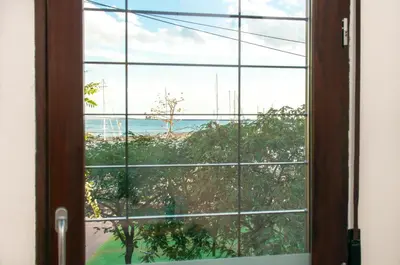 an open window with a view of the ocean at ecoGrusApartments in Masnou