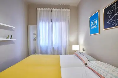 a bedroom with a large bed and a window at Spacious 3BRapartment in PobleSec with balcony in Barcelona