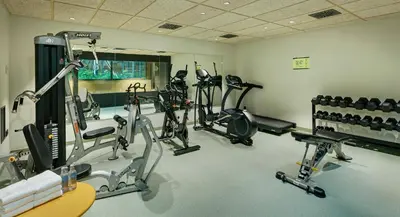 a gym with several treadmills and exercise bikes at Sercotel Barcelona El Prat in El Prat de Llobregat