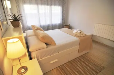 a bedroom with a large bed with a window at HomeHolidaysRentals Blue - Costa Barcelona in Pineda de Mar