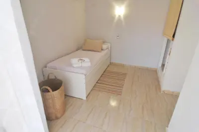 a small room with a bed and a basket at HomeHolidaysRentals Blue - Costa Barcelona in Pineda de Mar
