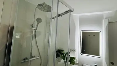 a shower with a glass door in a bathroom at Dúplex ático familiar by Prestigi in Terrassa