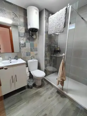a bathroom with a toilet and a shower and a sink at Apartamento con vista al mar in Vilanova i la Geltrú