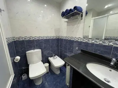 a bathroom with a toilet and a sink at Apartamento en el centro urbano in Vilanova i la Geltrú